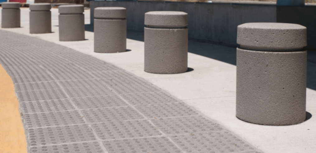 Short cylindrical bollards by bike path