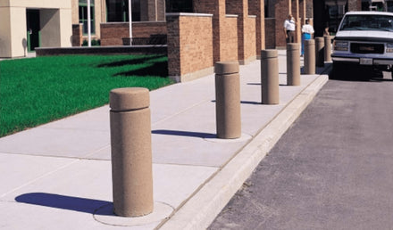 Single Reveal Line Cylindrical Bollard along sidewalk path and road