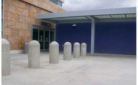 Heavy Duty concrete security bollard with three reveal lines at a drop off and pick up area