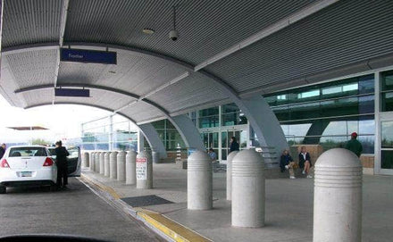 Heavy Duty concrete security bollard with three reveal lines at an airport